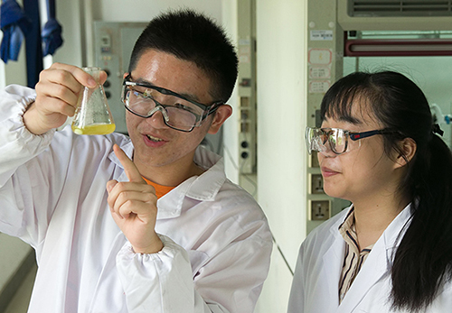 Scientists in lab coats chemistry experiment